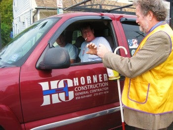 Neil Harmon donates to John Howlans as the Fox Chase Lions collect for White Cane Day. Neil Harmon donates to John Howlans as the Fox Chase Lions collect for White Cane Day.