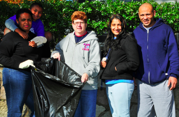L to R: Jeanette Newman with son Jordan, St. William's fifth grade teacher Kathy Mcdonald, and Summer and Kenny Rivera at the annual Grove Cleanup in Lawncrest. Photo by Stephen Schultz